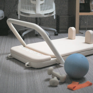 Somato Reformer setup with a Pilates ball for an at-home workout.