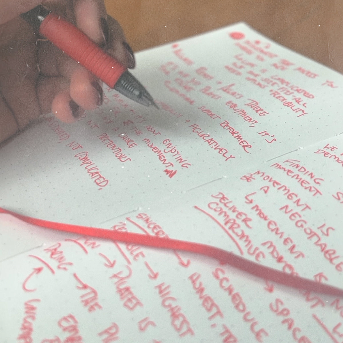 Close-up of our founder drafting Somato’s brand mission and values in a notebook.